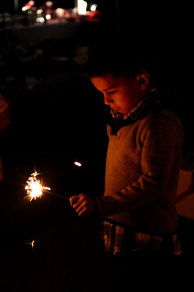 A boy with birthday party sparklers