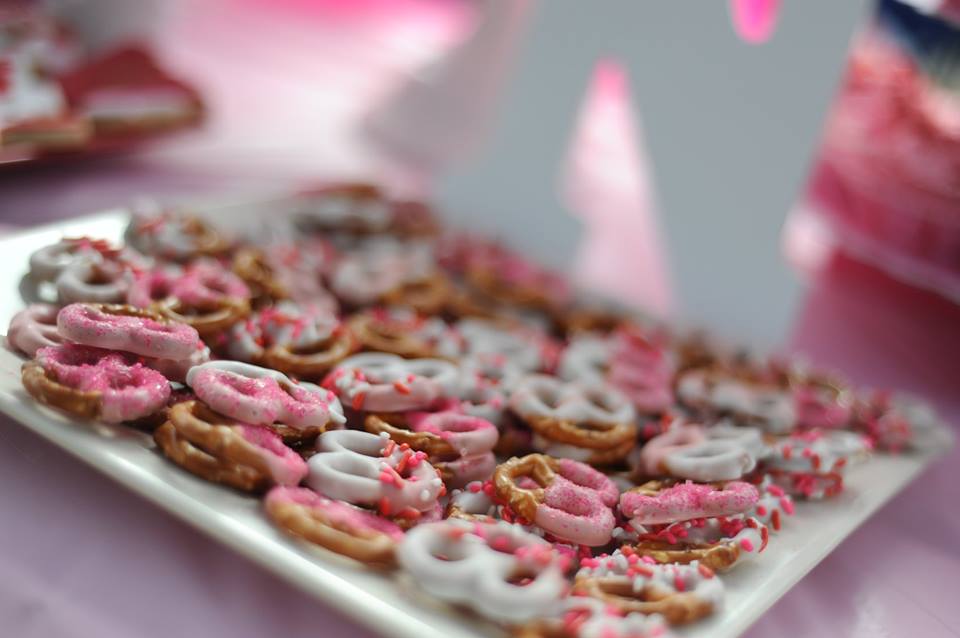 Pink chocolate-dipped pretzels