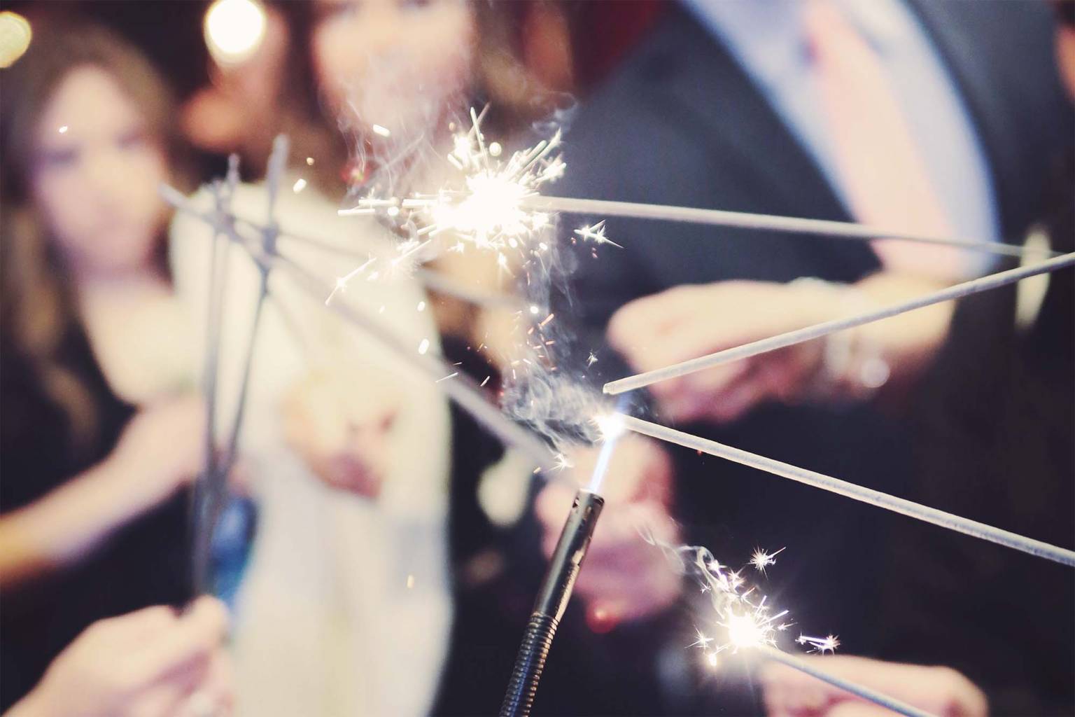 Lighting sparklers before a wedding exit