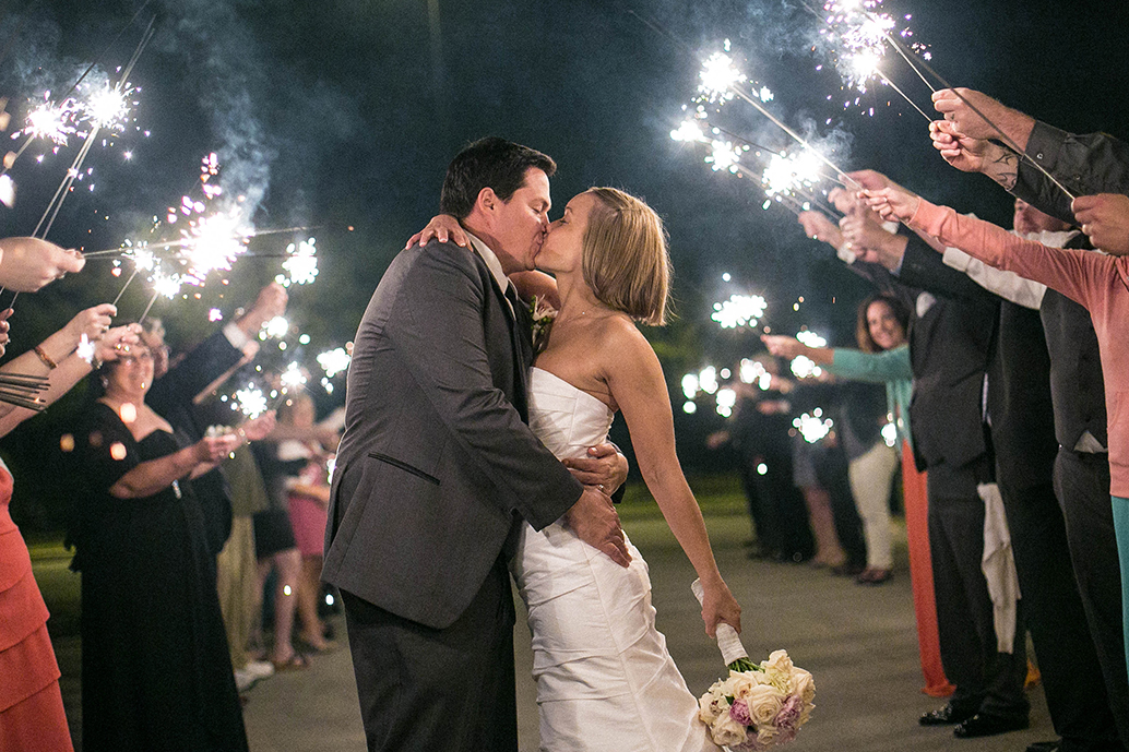 Wedding couple photographed during a sparkler exit without flash